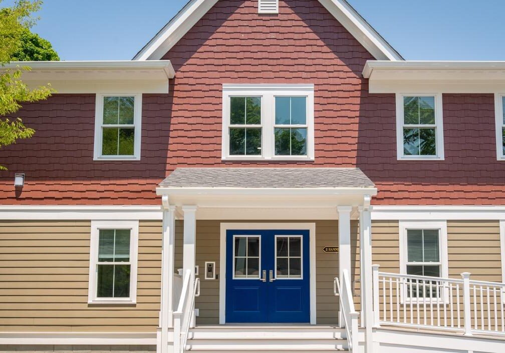 2Hammett Ct_ 2 story New England style residential building_tan with marroon upper level and front porch framed by 2nd story roof peak
